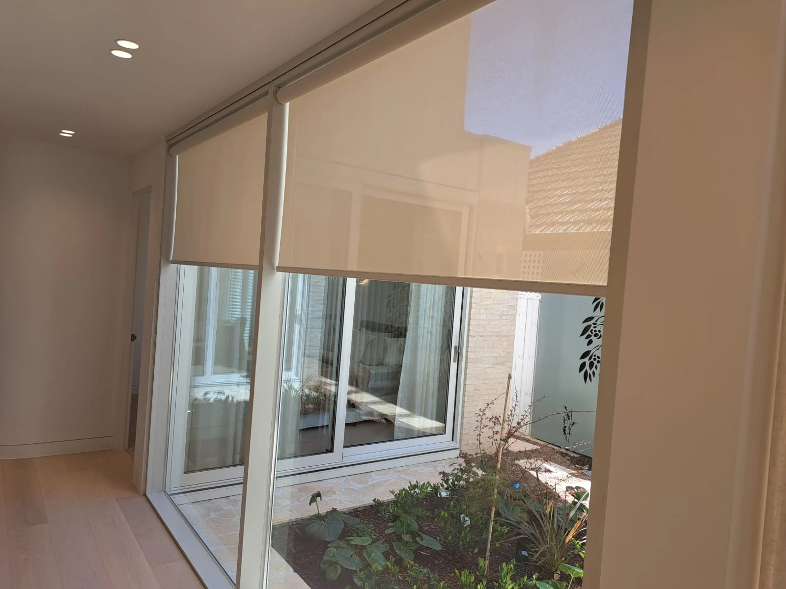 Light-filtering roller blinds facing an internal courtyard